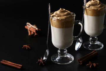 Dalgona creamy coffee in two glasses on a black background with whipped foam. Korean coffee trend, Closeup, Horizontal format