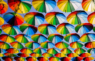 Fototapeta na wymiar Colorful umbrellas background. Colorful umbrellas in the sky. Street decoration. Ready for the rain, wallpaper background, bright various colors, beautiful scene.