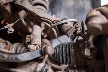 Inspects suspension, steering parts, tie rod ends. Car on a repair stand. Technical service station for car.