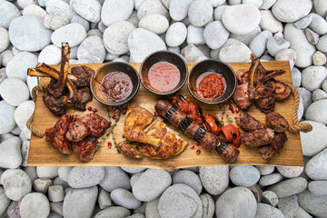 grilled meat on a large cooking board
