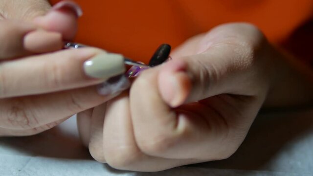 Woman Doing Her Own Manicure By Using Nail File and other Equipments