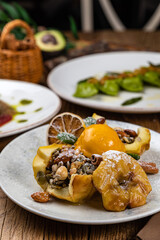 Dessert with baked apple, cinnamon, raisins and ice cream
