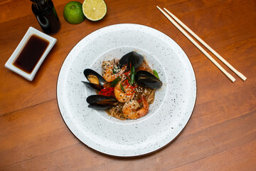 Traditional asian noodles with prawns and mussels