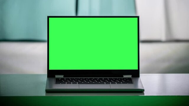 Working in the evening. Laptop with green screen. Zoom in. Template for keying 