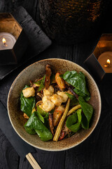 Funchoza noodles with tofu, shiitake mushrooms, mini corn, bell peppers, kumquat and spinach.