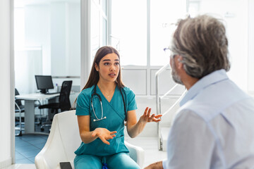 Doctor consulting patient in hospital waiting room. Patient sitting . Diagnostic, prevention of...