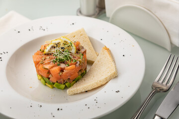 Salmon tartare on a white plate
