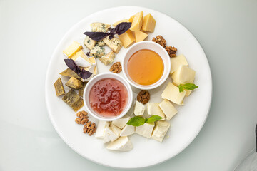 Plate with assorted cheeses and honey
