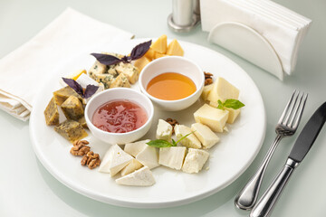 Plate with assorted cheeses and honey
