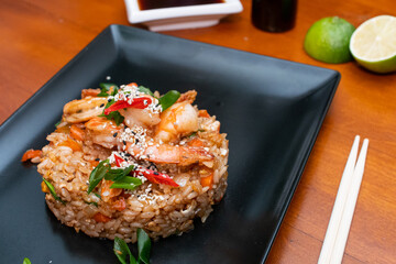 fried rice with shrimp, asian food on wooden table