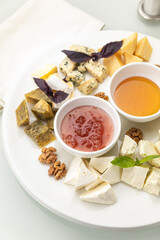 Plate with assorted cheeses and honey
