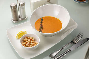 Soup in a white plate and a white background
