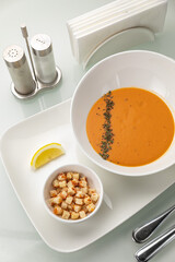 Soup in a white plate and a white background
