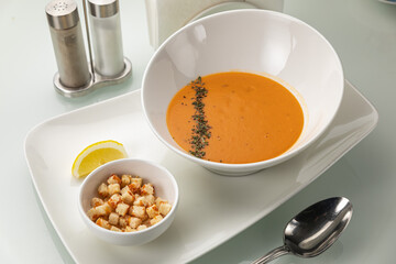 Soup in a white plate and a white background
