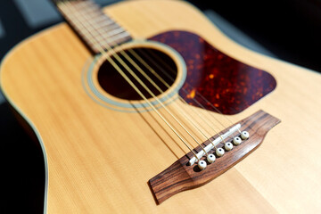 close up of acoustic guitar on window sill
