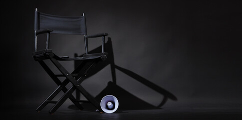 Black director chair and Clapper board or movie Clapperboard on black background.use in video production or film cinema industry