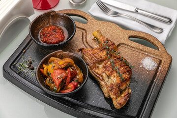 grilled meat on a large cooking board
