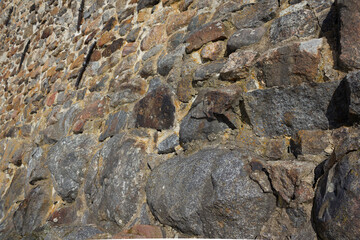 Close up shot of stone footing from the 17th century. Historic background with rock texture. 