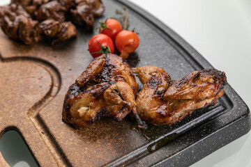 grilled meat on a large cooking board
