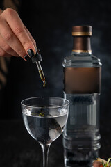 cocktail and food on a dark table
