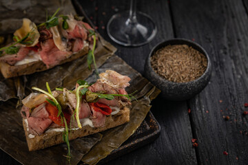 cocktail and food on a dark table
