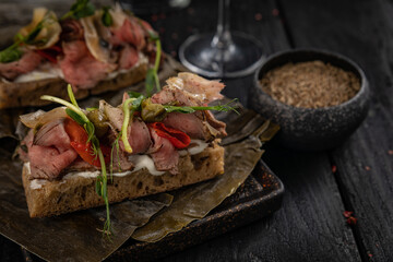 cocktail and food on a dark table
