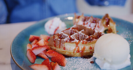 Waffle with ice cream and strawberry in restaurant