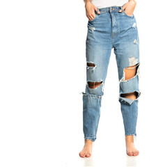 legs of a woman in ripped jeans