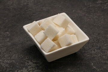 Refined white sugar cubs in the bowl