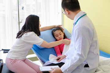 Mother caring of daughter during visit to doctor