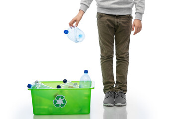 boy throwing plastic bottle into box
