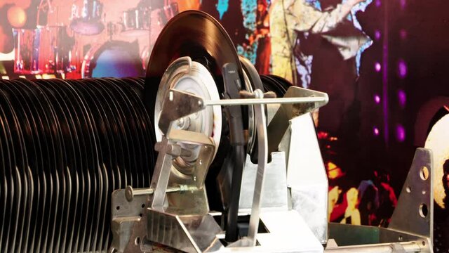 Fine shot Jukebox playing music from vinyl single record with old time classic mechanism.