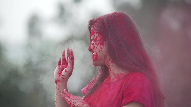 Indian Festival Holi Celebration Slowmotion.Indian Girl playing with colors, enjoying a festival of Colors Holi. High-quality 4k footage