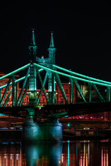 Fototapeta na wymiar Budapest at night, Freedom Bridge on the Danube River, reflection of night lights on the water