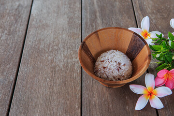 Rice in a wooden cup on a wooden floor table