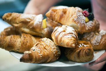 Freshly baked croissants on a plate with different fillings.