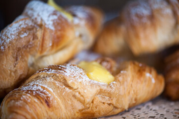 Freshly baked croissants on a plate with different fillings.