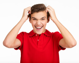 Photo of  young  screaming man looking at camera isolated on white background. Portrait of handsome guy touching his head with a expressive emotions .  Funny portrait of Teenager .