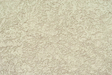 Plaster on a yellow wall. Concrete wall texture close up.