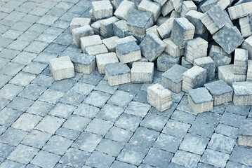 Brand new cobblestones on the pile. Blue granite cobblestones close up. Stone cubes for sidewalks. Repair of sidewalks.