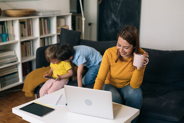 mother working from home. children are playing in background