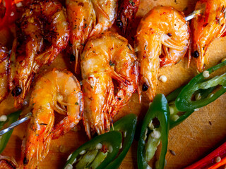 Delicious fried prawns on a skewer with sauce and lemon