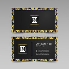 Golden mandala with business card on dark background