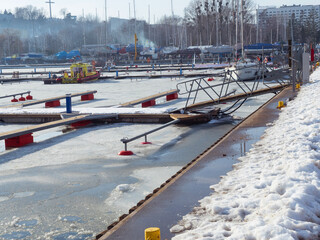 Marina in Gdynia during the winter snow day with walk people.