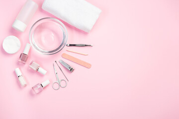 Spa set, manicure or pedicure equipment with nail coat or polish, on pink background, horizontal, copy space, top view