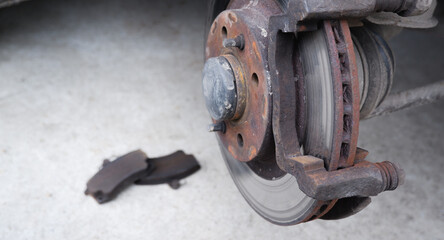 Car repair. Replacing the brake pads of disc brakes. Brake disc close-up.