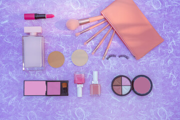 Cosmetics makeup product on purple mulberry paper background.