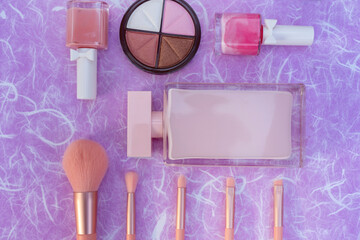 Naklejka premium Cosmetics makeup product on purple mulberry paper background.
