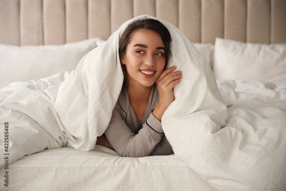 Canvas Prints Beautiful young woman wrapped with soft blanket relaxing in bed at home