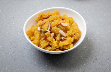 Moong Dal Halwa or Mung Daal Halva is an Indian dessert recipe, made with mung lentil, clarified butter and sugar, garnished with dry fruits